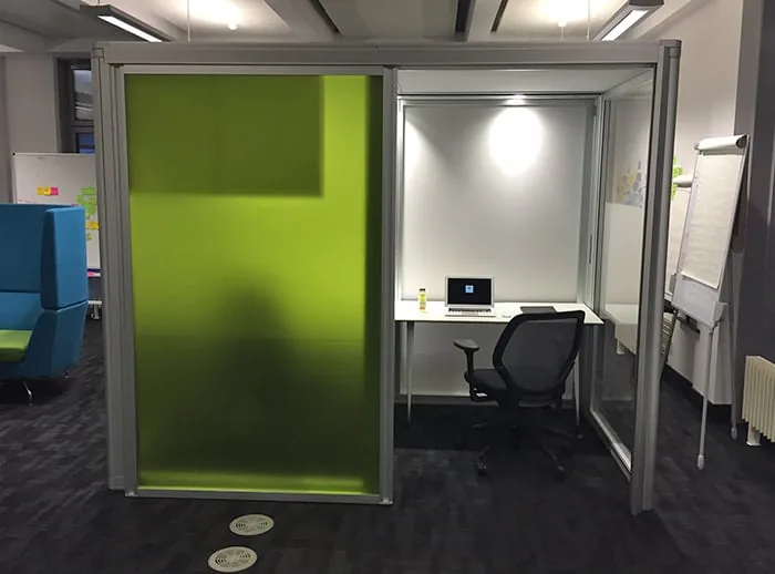 The participant pod: a small enclosed booth with a laptop on a desk